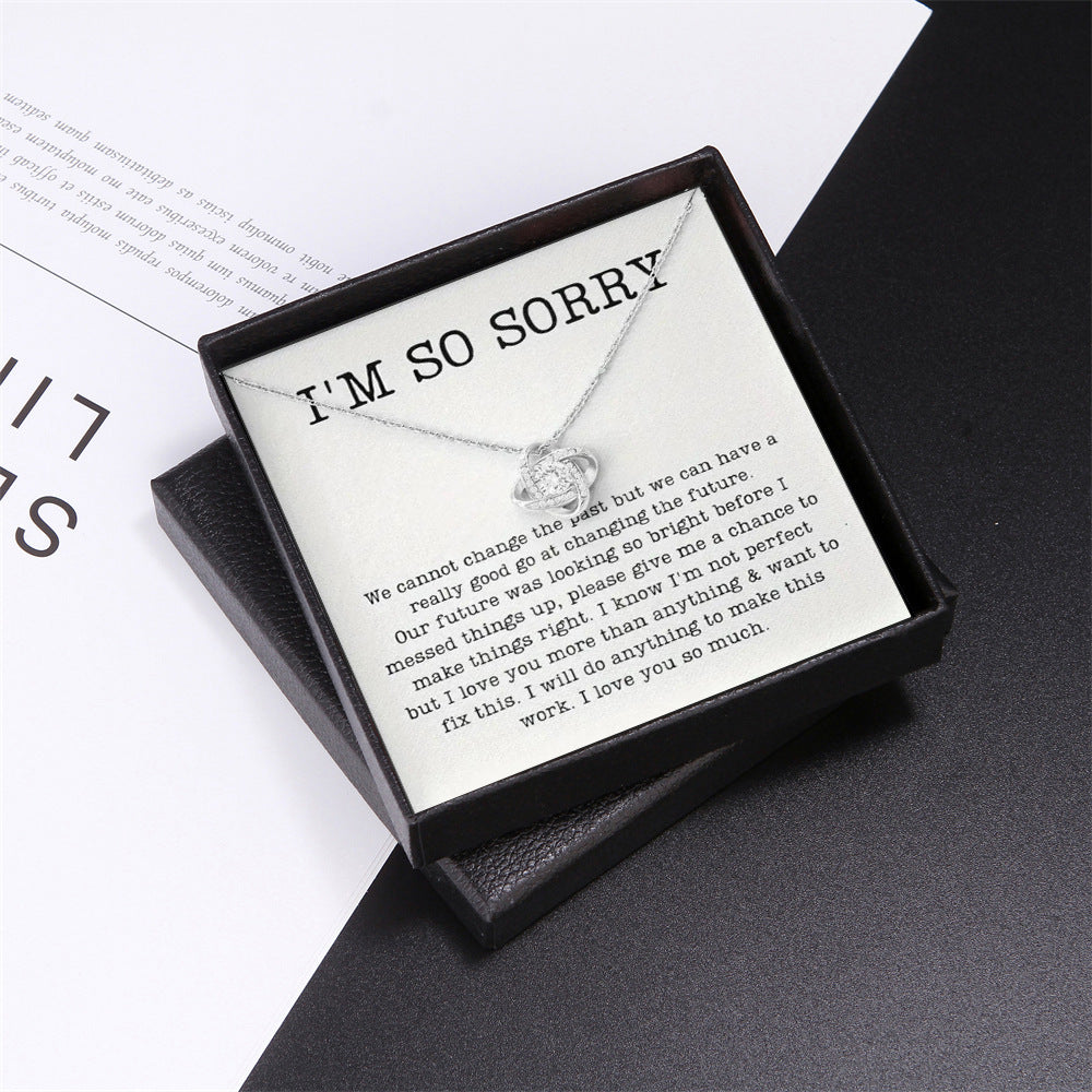 Necklace with a message card in a black box on a white background